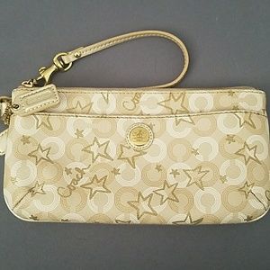 Authentic Coach gold star wristlet.